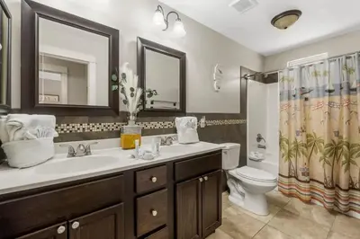 a bathroom with a sink and a toilet at Basking by the Beach in Panama City Beach