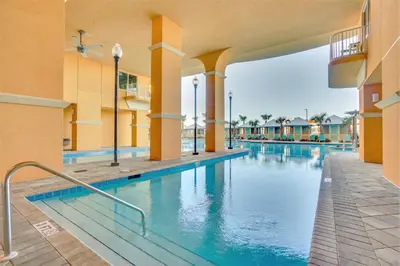a swimming pool at a resort with blue water at Calypso Resort Tower 3 by Panhandle Getaways in Panama City Beach