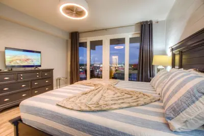 a bedroom with a large bed with a large window at BRAND NEW! Laketown Wharf 633! Amazing 3 BD, Great Location, And Awesome Amenities! in Panama City Beach
