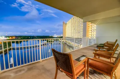 a balcony with chairs and a view of the water at BRAND NEW! Laketown Wharf 633! Amazing 3 BD, Great Location, And Awesome Amenities! in Panama City Beach