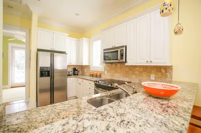 a kitchen with a sink and a counter top at 30A Beach House - Sunny Daze by Panhandle Getaways in Panama City Beach