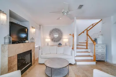a living room with a white couch and a fireplace at 30A Beach House - Stillwater Cottage by Panhandle Getaways in Rosemary Beach