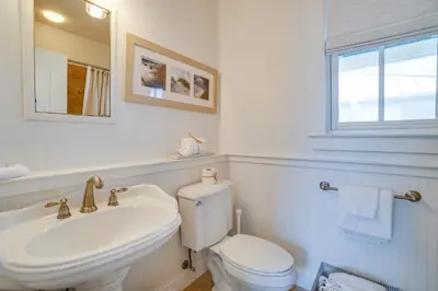 a white bathroom with a toilet and a sink at 30A Beach House - Stillwater Cottage by Panhandle Getaways in Rosemary Beach