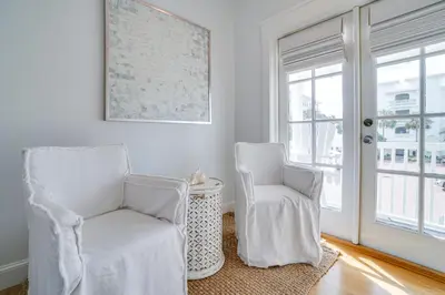 two white chairs in a room with a window at 30A Beach House - Stillwater Cottage by Panhandle Getaways in Rosemary Beach
