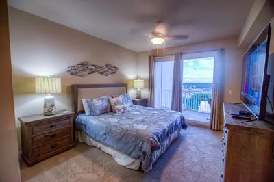 a bedroom with a bed and a tv and a window at Next To The 10th Floor Pool - Laketown Wharf 1032- 2 BD Plus Bunks, 2BA, And Amazing Amenities! in Panama City Beach