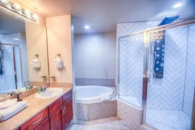 a bathroom with a tub and a sink and a shower at Next To The 10th Floor Pool - Laketown Wharf 1032- 2 BD Plus Bunks, 2BA, And Amazing Amenities! in Panama City Beach