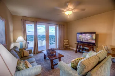 a living room with two couches and a flat screen tv at Next To The 10th Floor Pool - Laketown Wharf 1032- 2 BD Plus Bunks, 2BA, And Amazing Amenities! in Panama City Beach