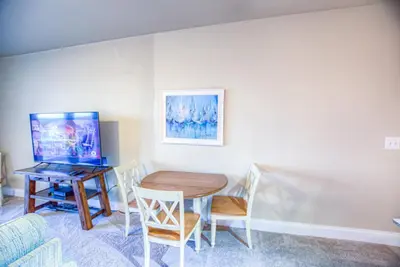 a dining room with a table and a desk at Next To The 10th Floor Pool - Laketown Wharf 1032- 2 BD Plus Bunks, 2BA, And Amazing Amenities! in Panama City Beach