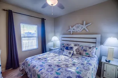 a bedroom with a bed with pillows and a window at Next To The 10th Floor Pool - Laketown Wharf 1032- 2 BD Plus Bunks, 2BA, And Amazing Amenities! in Panama City Beach