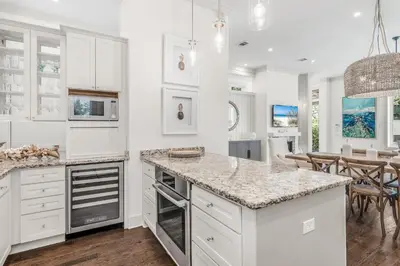 a kitchen with white cabinets and a counter top at Rolling Dunes in Inlet Beach