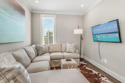 a living room with a couch and a flat screen tv at Rolling Dunes in Inlet Beach