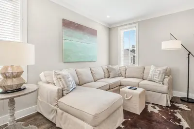 a white living room with a couch and a table at Rolling Dunes in Inlet Beach