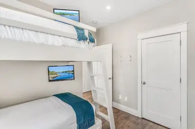 a bedroom with a bunk bed and a ladder at Rolling Dunes in Inlet Beach