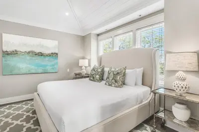 a white bedroom with a bed and a window at Rolling Dunes in Inlet Beach