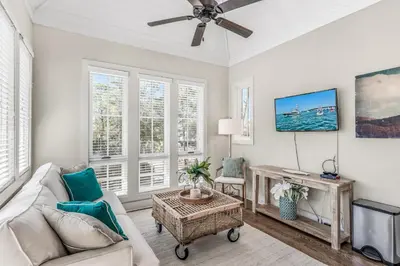 a living room with a couch and a ceiling fan at Rolling Dunes in Inlet Beach