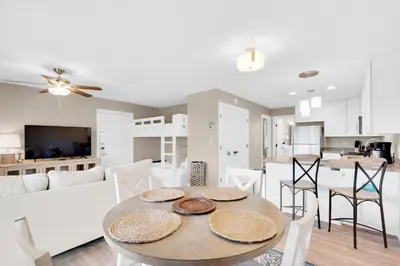 a kitchen and living room with a table and chairs at Beachwood Villas 6D- Beach Time Oasis in Santa Rosa Beach