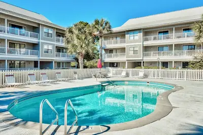 a swimming pool in front of a apartment building at Beachwood Villas 6D- Beach Time Oasis in Santa Rosa Beach