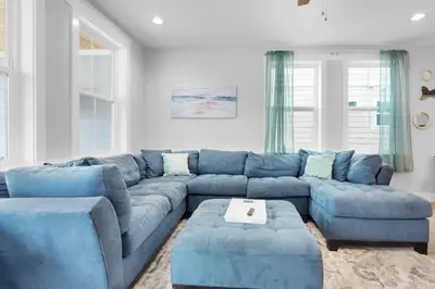 a blue sectional couch in a living room at Blue Mermaid in Panama City Beach