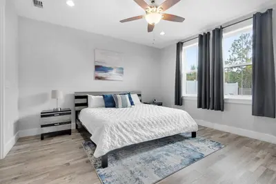 a bedroom with a bed and a ceiling fan at Blue Mermaid in Panama City Beach