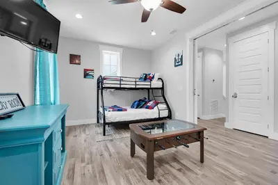 a room with a bunk bed and a coffee table at Blue Mermaid in Panama City Beach