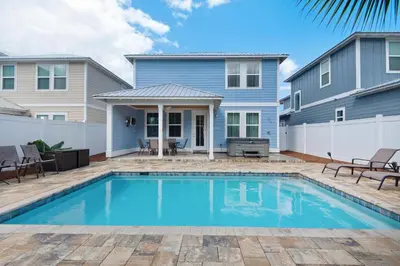 a house with a swimming pool in front of a house at Blue Mermaid in Panama City Beach