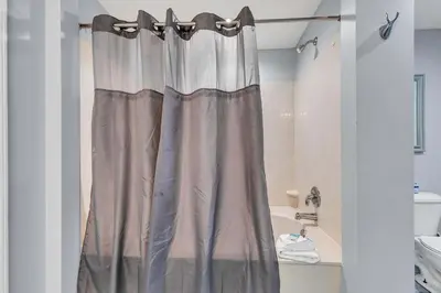 a shower curtain in a bathroom with a tub at Sterling Reef 401 in Panama City Beach