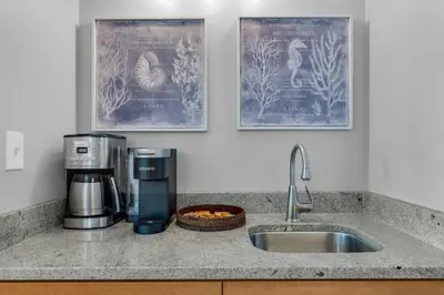 a kitchen counter with a coffee maker and a sink at Calypso 1-2208 East in Panama City Beach