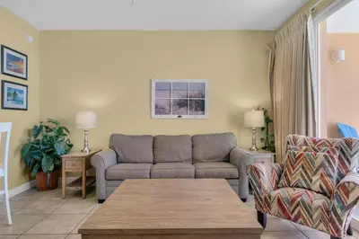 a living room with a couch and a table at Splash 1803E in Panama City Beach