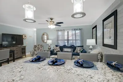 a living room with a couch and a table at Horizon South 74F in Panama City Beach