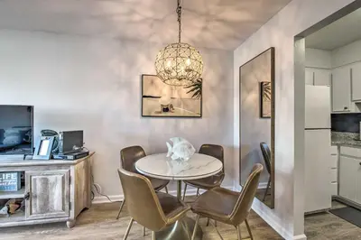 a dining room with a table and chairs at PCB Condo Rental with Pool Access, Steps to Beach! in Panama City Beach