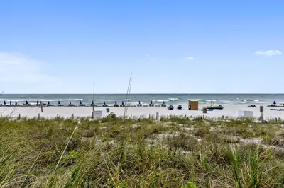 a beach with a lot of people in the water at Emerald Beach #1227 by Book That Condo in Panama City Beach