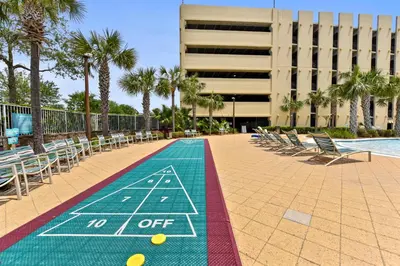 a sign that says no off with chairs and a pool at Emerald Beach #1227 by Book That Condo in Panama City Beach