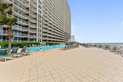 a swimming pool in front of a large building at Emerald Beach #1227 by Book That Condo in Panama City Beach