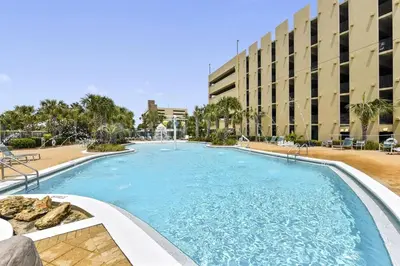 a large swimming pool in front of a building at Emerald Beach #1227 by Book That Condo in Panama City Beach