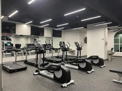 a gym with a lot of cardio equipment in a room at Calypso 3-2303 Penthouse Level w/ Incredible View! in Panama City Beach