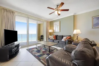 a living room with a couch and a flat screen tv at PARKING INCLUDED-Beachfront 2BD Ocean Villa! Gorgeous Amenities, Private Complex in Panama City Beach