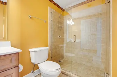 a bathroom with a toilet and a glass shower at PARKING INCLUDED-Beachfront 2BD Ocean Villa! Gorgeous Amenities, Private Complex in Panama City Beach