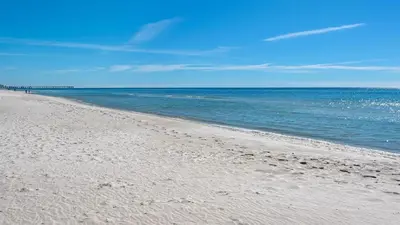 a sandy beach with the ocean in the background at PARKING INCLUDED-Beachfront 2BD Ocean Villa! Gorgeous Amenities, Private Complex in Panama City Beach