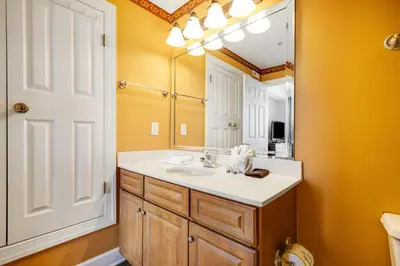 a bathroom with a sink and a mirror at PARKING INCLUDED-Beachfront 2BD Ocean Villa! Gorgeous Amenities, Private Complex in Panama City Beach