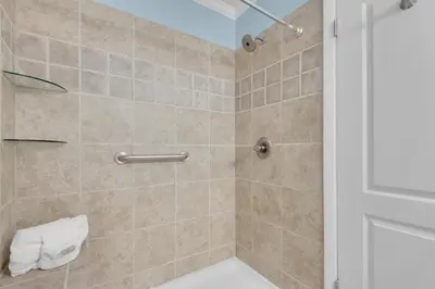 a bathroom with a shower stall with a toilet at Polynesian Village 211 in Panama City Beach