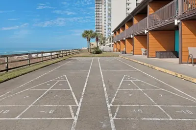 an empty parking lot next to the beach at Polynesian Village 211 in Panama City Beach