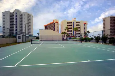a tennis court in a city with tall buildings at Summerhouse 502A in Panama City Beach