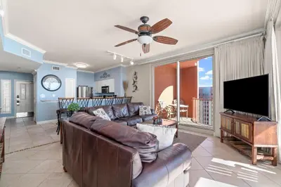 a living room with a couch and a flat screen tv at Summer By The Sea Unit 2203 in Panama City Beach