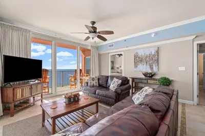 a living room with a couch and a flat screen tv at Summer By The Sea Unit 2203 in Panama City Beach