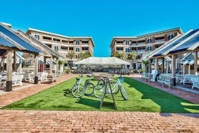 a group of bikes parked on a lawn in front of a building at 30A Villages of South Walton by Panhandle Getaways in Seacrest