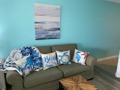 a living room with a couch with pillows on it at Lullwater Condos 291 in Panama City Beach