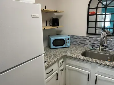 a kitchen with a white refrigerator and a sink at Lullwater Condos 291 in Panama City Beach