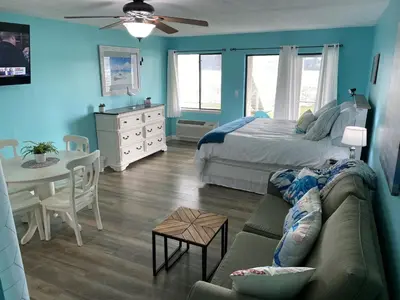 a living room with a couch and a bed and a table at Lullwater Condos 291 in Panama City Beach