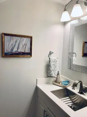 a bathroom with a sink and a mirror at The Nest Egg in Panama City Beach
