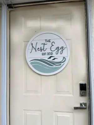 a door with the next egg sign on it at The Nest Egg in Panama City Beach